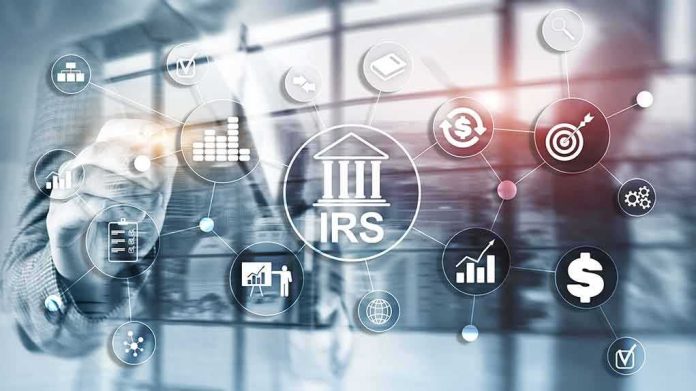 shutterstock_1383304889 Businessperson interacting with IRS finance icons on a transparent screen