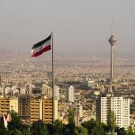 Tehran On Edge: Checkpoints Everywhere Iranian flag over Tehran skyline with Milad Tower