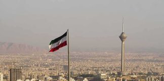 Tehran On Edge: Checkpoints Everywhere Iranian flag over Tehran skyline with Milad Tower