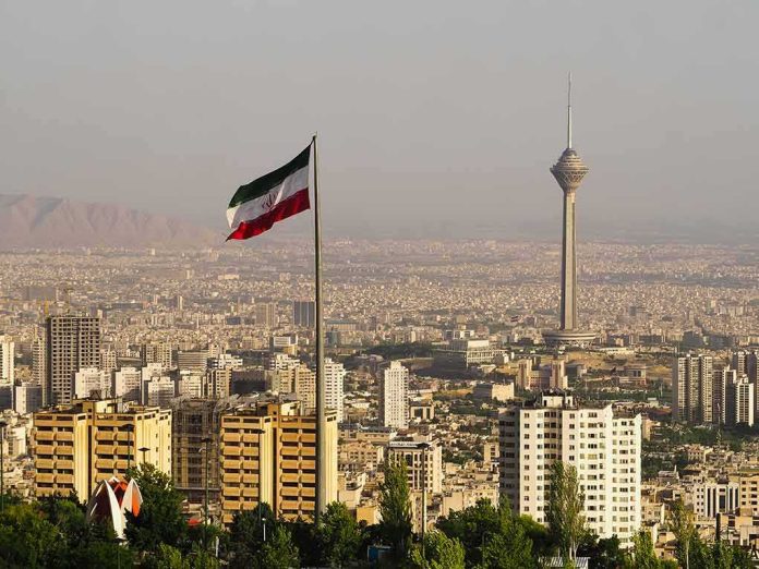 shutterstock_1415273714 Iranian flag over Tehran skyline with Milad Tower