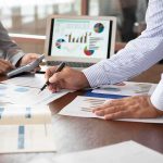 Hiring Boom Hype? The Ominous Footnote Business colleagues reviewing financial charts at a desk