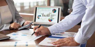 Business colleagues reviewing financial charts at a desk