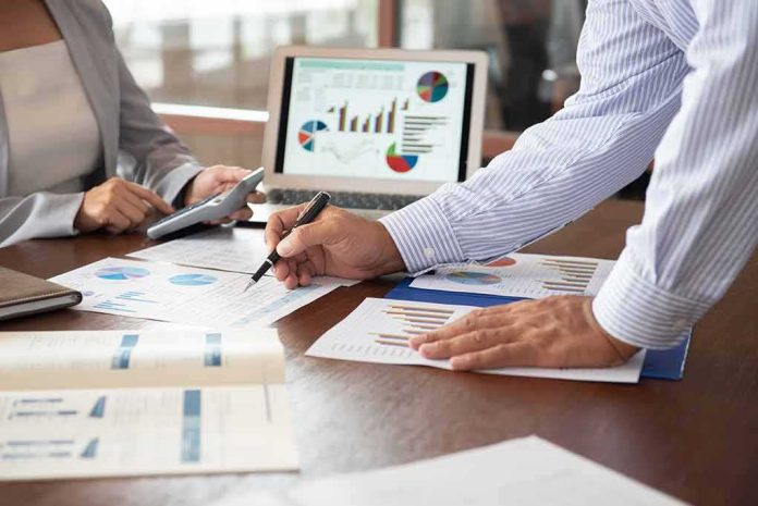 Business colleagues reviewing financial charts at a desk