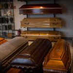 4 Kids Dead, Many Warnings, What Happened Row of coffins displayed in a funeral home showroom