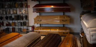 4 Kids Dead, Many Warnings, What Happened Row of coffins displayed in a funeral home showroom