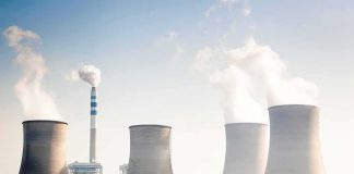 Cooling towers emitting steam at an industrial power plant