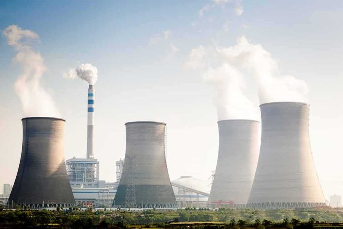 shutterstock_164603351 Cooling towers emitting steam at an industrial power plant