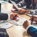 Billion-Dollar Gray Zone Around Trump Heirs business team reviewing charts at a meeting table