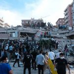 Civilian Sites Ablaze In Kyiv Rescue workers and civilians on collapsed building after earthquake