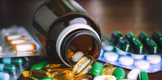 Hospital Superbug’s Sweet Tooth Exposed Assorted pills and capsules spilling from a brown bottle