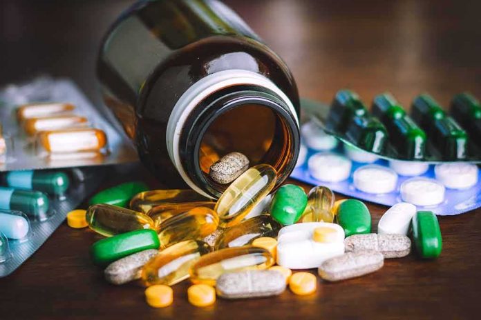 shutterstock_1898898127 Assorted pills and capsules spilling from a brown bottle