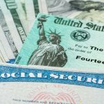 Social Security card and U.S. Treasury check on cash