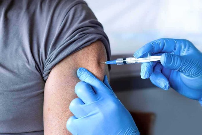 shutterstock_1973420396 Healthcare worker giving an arm injection