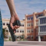 Bus Stop Gun Draw Sparks NAACP Fury Person holding a handgun near a school building