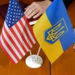 Moscow-to-Kyiv Gambit Stuns Diplomats U.S. and Ukrainian flags on a table