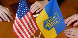 U.S. and Ukrainian flags on a table