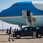 Homeland Chief’s Plane: Mayday Over Washington Security detail near blue and white aircraft with staircase and SUV