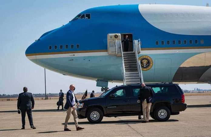 shutterstock_2047086128 Security detail near blue and white aircraft with staircase and SUV