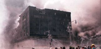 Emergency responders and civilians amidst debris at a disaster site