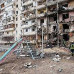 Tourist District Leveled – What Sparked Athens Inferno? Damaged apartment building behind a playground slide
