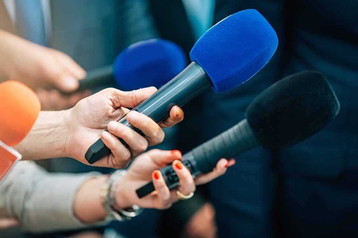 shutterstock_2168392339-1 Reporters holding colorful microphones