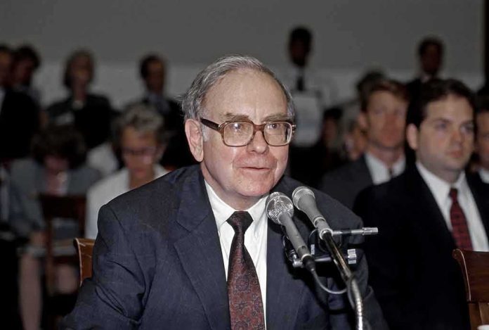 shutterstock_2177551623 Older man in suit speaking at microphones during hearing
