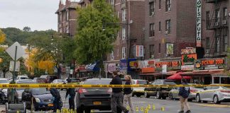 Unarmed Student Killed—Cop Charged Police investigate a taped-off urban street crime scene