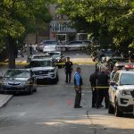 High-Rise Carnage Triggers Citywide Panic Police officers secure a residential street with patrol cars and yellow tape