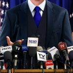 Showdown Brewing: Trump vs. Tapper A speaker at a press conference with multiple microphones in front of them