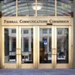 Sanctuary Showdown: Billions At Risk Federal Communications Commission building entrance with gold doors