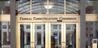 Sanctuary Showdown: Billions At Risk Federal Communications Commission building entrance with gold doors
