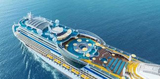 Cruise ship upper decks with pools and lounge areas at sea