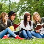 Harvard’s A Grade CAP: Radical Academic Shake-Up! Group of young women reading books on grass in a park
