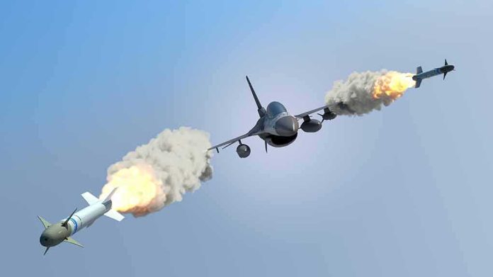 shutterstock_317815559 fighter jet firing two missiles in flight