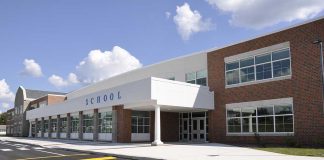 Supreme Court Lets Schools Hide Gender Changes Modern school building with large windows and a clear sky