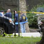 Protesters Misfire: Harass Grieving FBI Director! law enforcement officers gather at taped-off outdoor scene