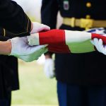 Non-Combat Death Raises Big Questions Military personnel folding a flag during a ceremonial event