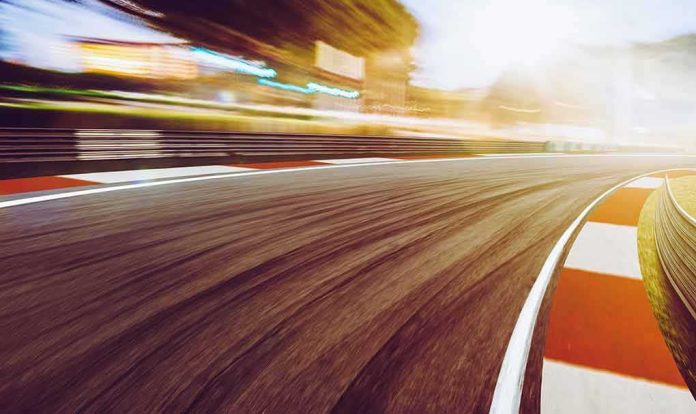 shutterstock_563321110 race track curve at sunset with motion blur