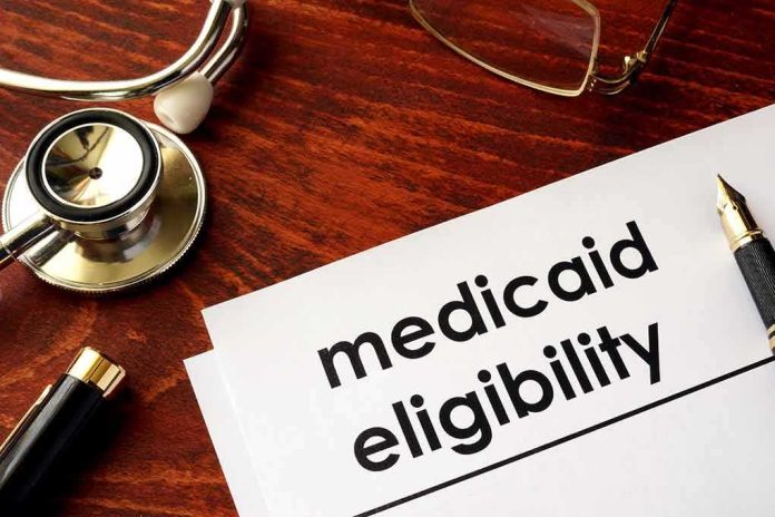 Medicaid eligibility form with stethoscope and pen on desk
