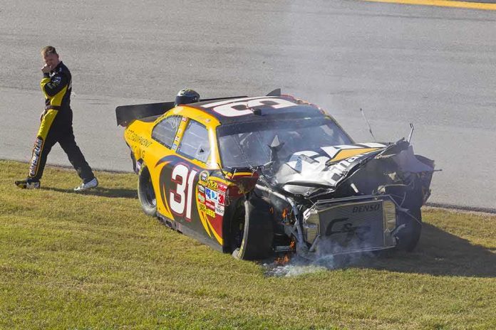 Race car with heavy front-end damage on grass