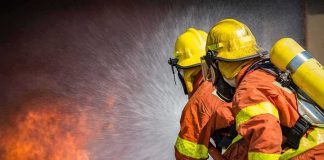 Firefighters spraying water on a blaze