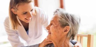 Caregiver smiling at an elderly woman