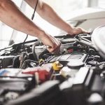 Trump Slams Ford, GM Over Fixes Mechanic working on a car engine bay
