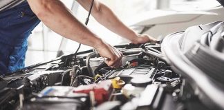 Mechanic working on a car engine bay
