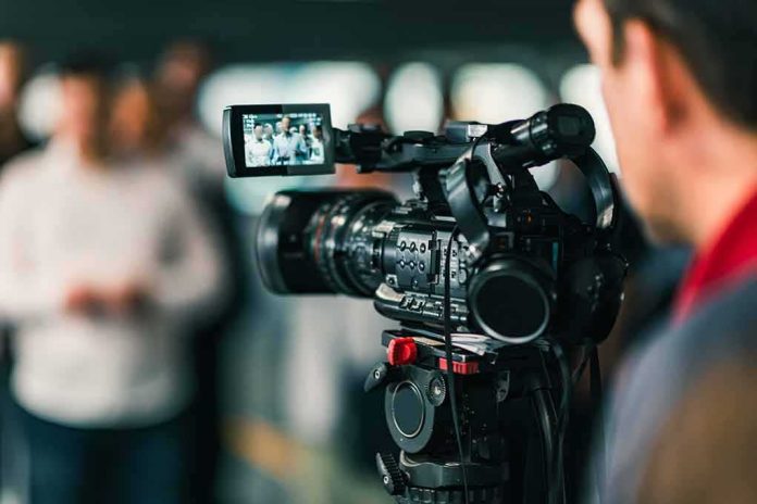 Video camera filming a group of people