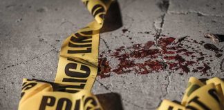 River Trail Serial Killer Spooks Lansing Crime scene tape near blood on pavement