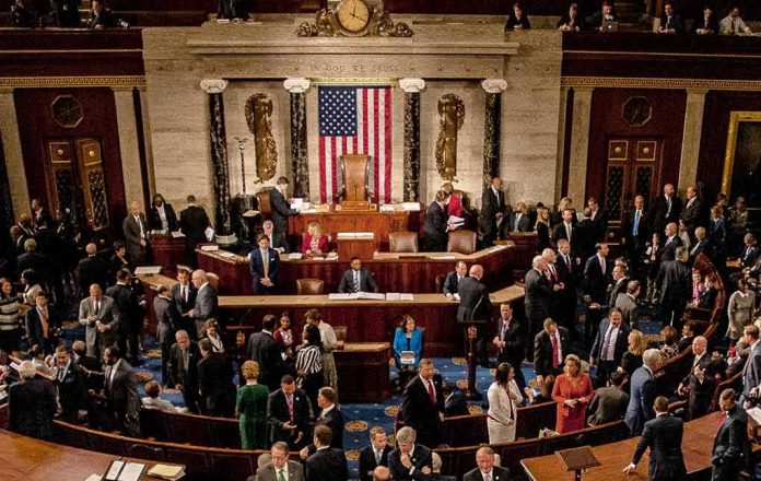 shutterstock_1186368265-1 Leonard Lance and Claude Guéant among lawmakers on a legislative chamber floor