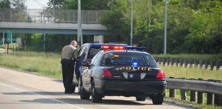 Police officer conducting a traffic stop on a highway