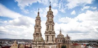 historic cathedral with twin towers in a colonial cityscape