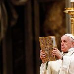 Vatican Jitters: Pope Heads Into Surgery Catholic priest holds ornate book during ceremony